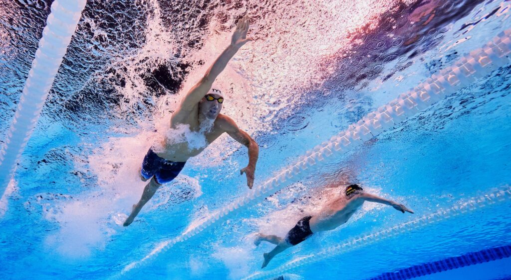 Bobby Finke and Sven Schwarz swimming at 2024 Summer Olympics.