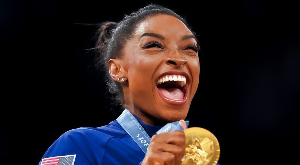 Simone Biles celebrates with her gold medal.