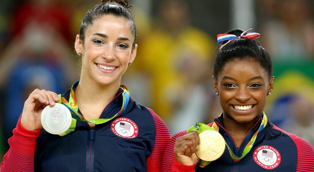 Simone Biles and Aly Raisman posing with medals