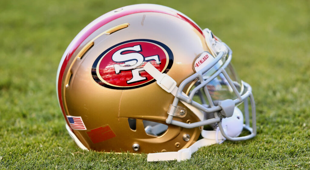 San Francisco 49ers helmet shown on ground.