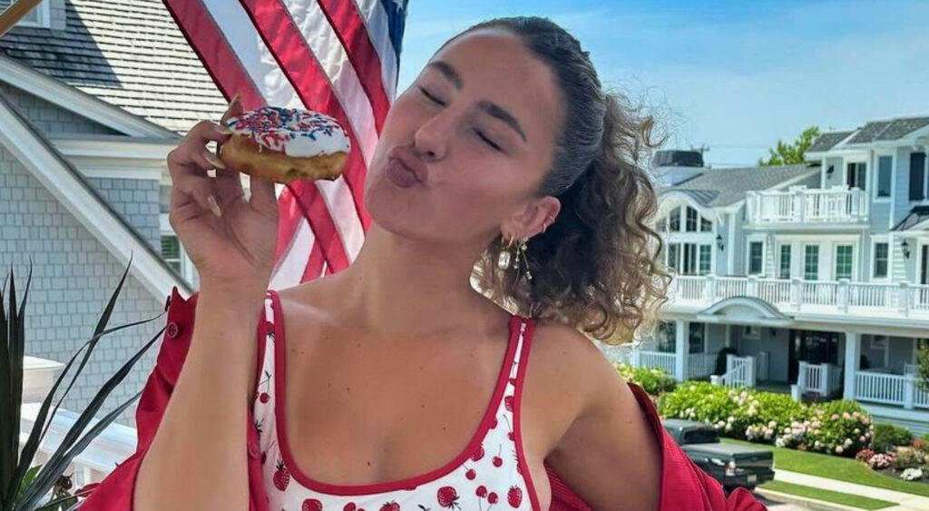 Gia Duddy holding a donut