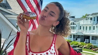 Gia Duddy holding a donut