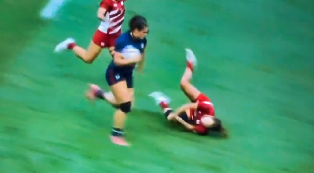 Ilona Maher stiff arms her opponent to the ground at the Olympic Games.