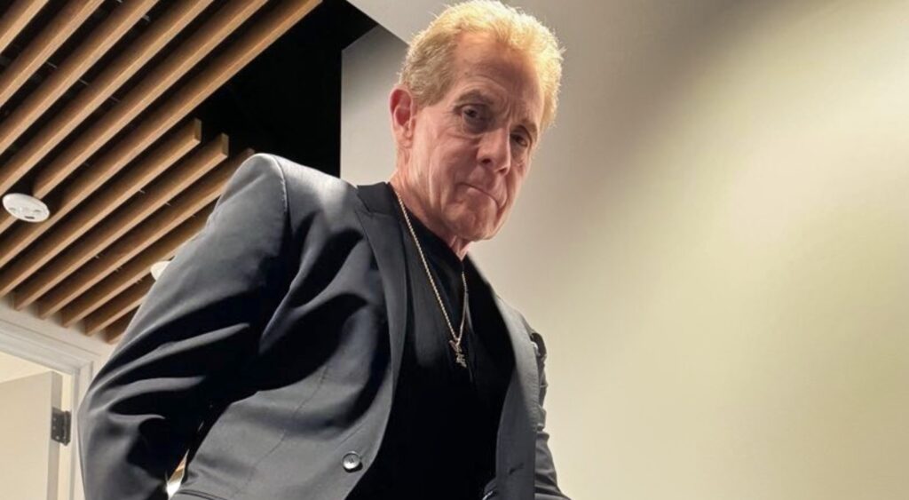 Skip Bayless posing in suit