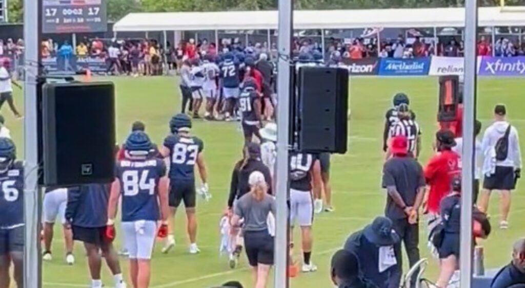 Stefon Diggs and Texans teammates on field fighting during practice.