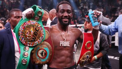 Terence Crawford celebrates with his championship belts