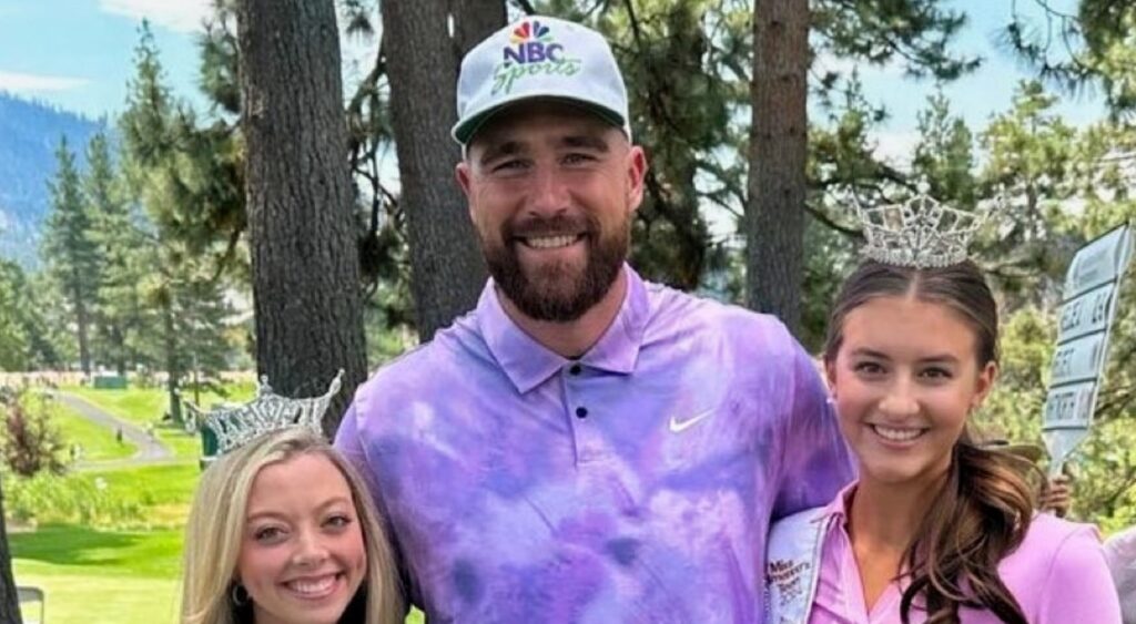 Travis Kelce posing with two girls