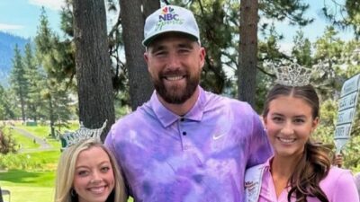 Travis Kelce posing with two girls