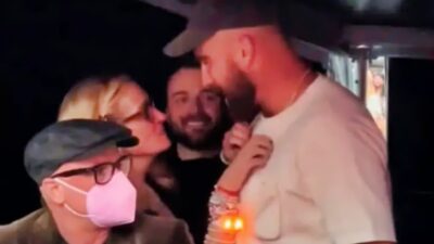 Travis Kelce and Julia Roberts talking at concert