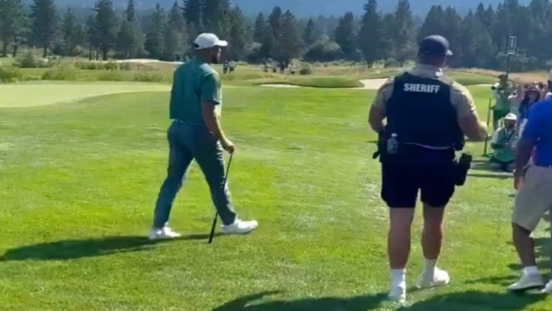 Travis Kelce of Kansas City Chiefs walking at golf event.