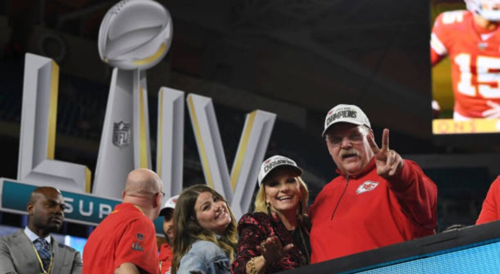 Andy Reid victorious on stage with wife Tammy after winning game