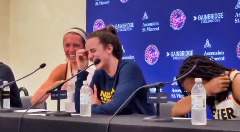 Caitlin Clark laughing during a press conference.