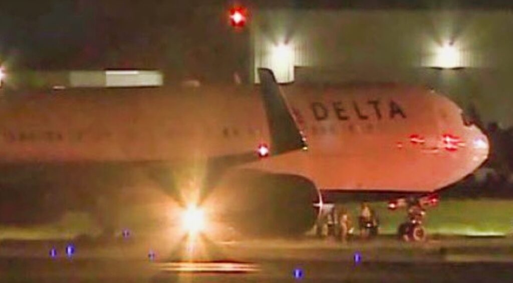 Delta Plane carrying Carolina Panthers players on the runway.