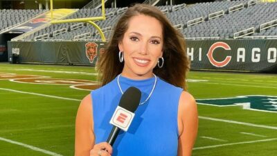 Courtney Cronin holding microphone on Bears football field