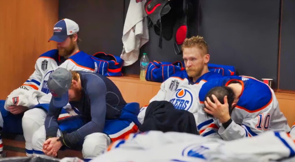 Edmonton Oilers players sad in their locker room.