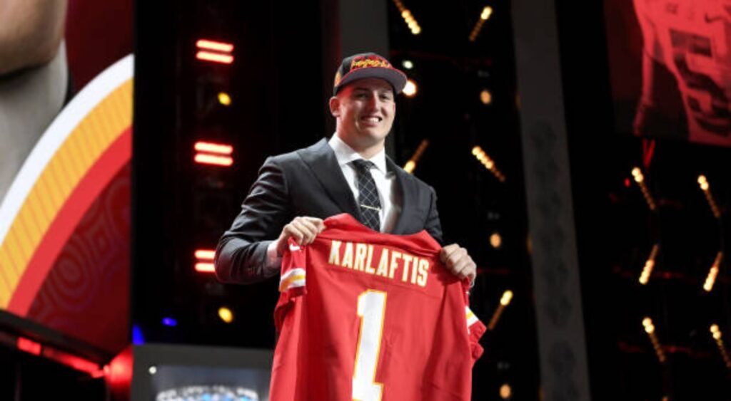 George Karlaftis poses onstage after being selected