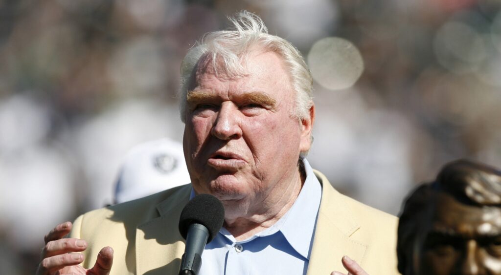 John Madden speaking at event.