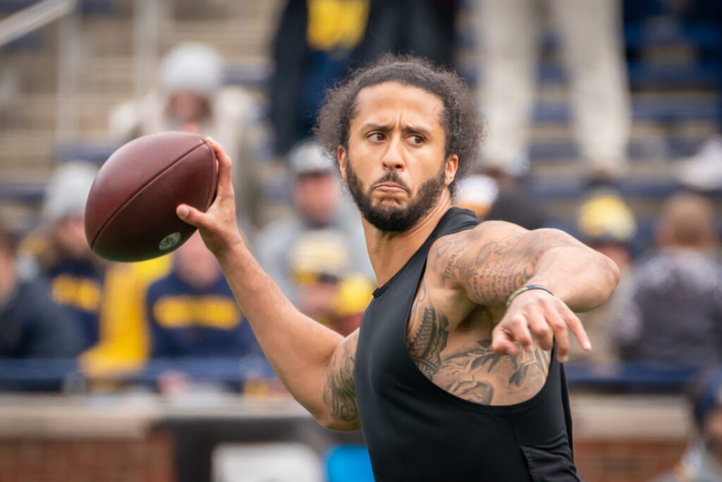 Colin Kaepernick throwing football.