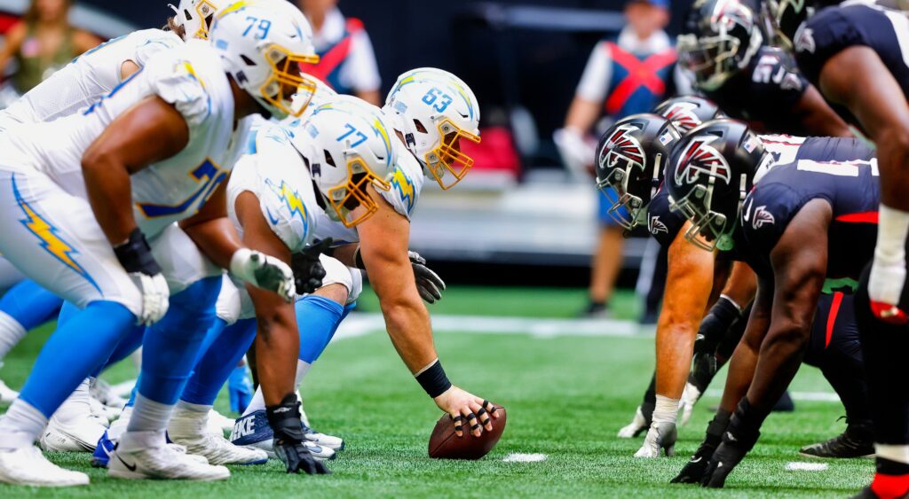 Chargers and Falcons players  at line of scrimmage