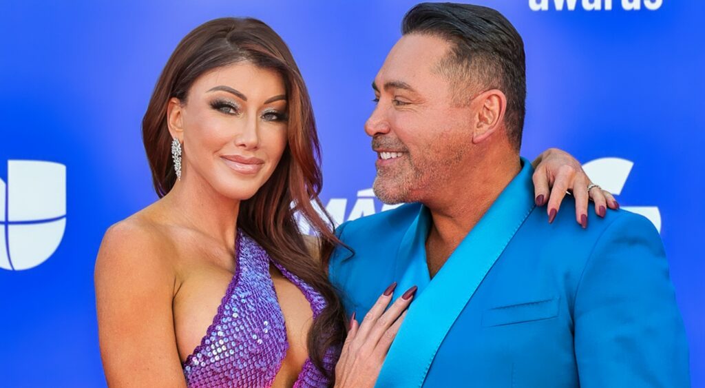 Holly Sonders and Oscar De La Hoya pose on the red carpet.