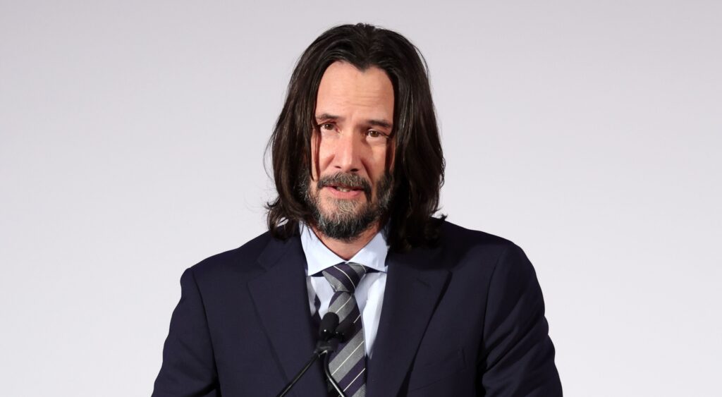 Keanu Reeves speaking at a gala in 2023