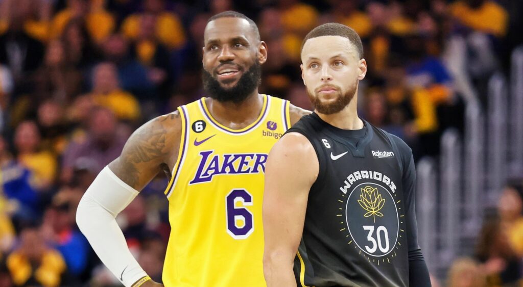 LeBron James and Stephen Curry looking on during game.