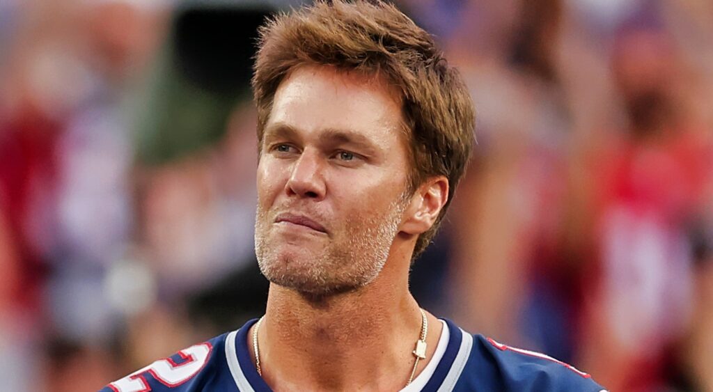 Tom Brady looks on.