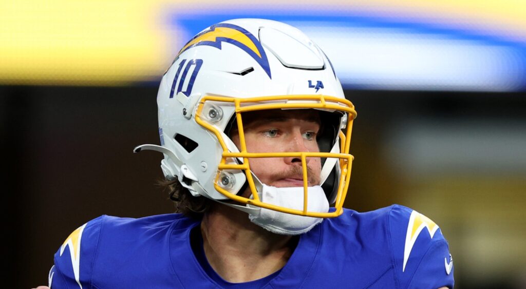 Justin Herbert of Los Angeles Chargers looking on.