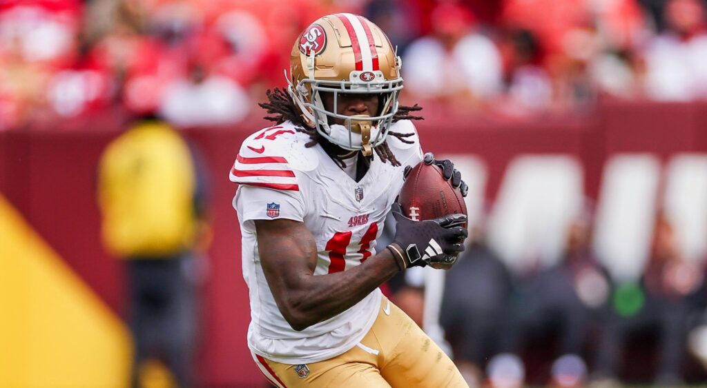 Brandon Aiyuk of San Francisco 49ers running with football.