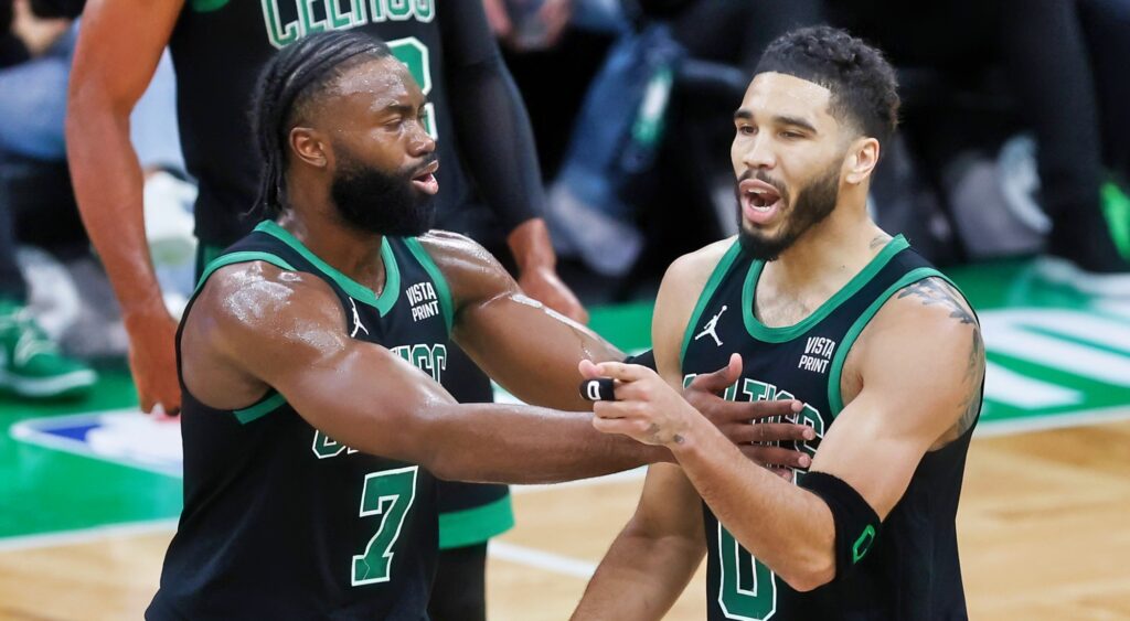 Jayson Tatum and Jaylen Brown reacting during game.