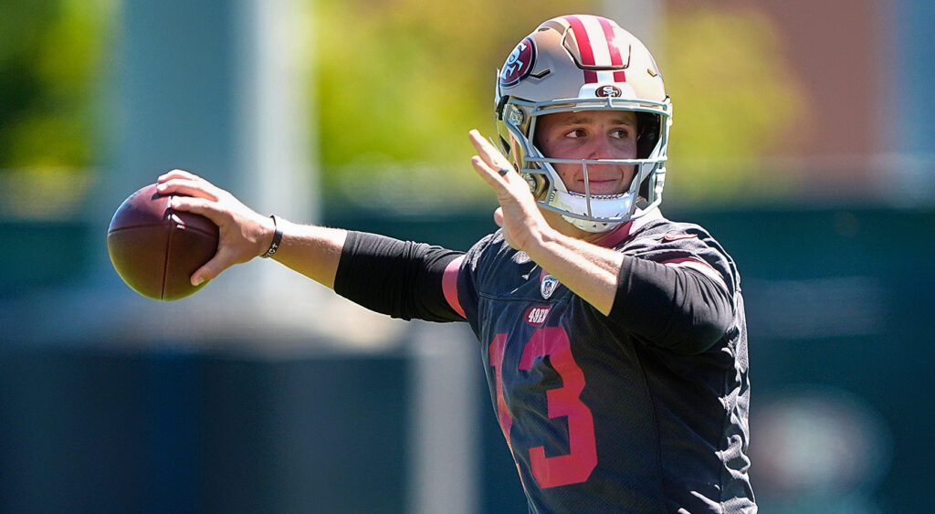 Brock Purdy of San Francisco 49ers looking on.