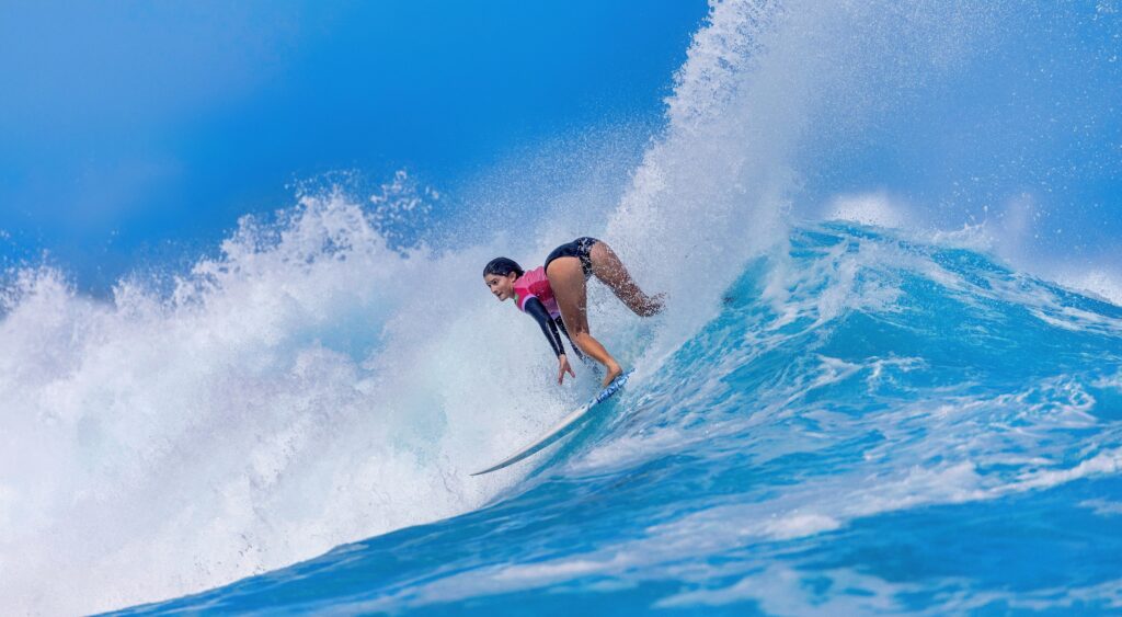 Female competing in Olympic surfing.