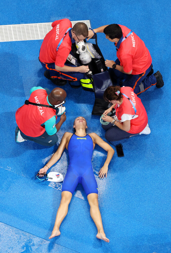 Tamara Potocka receives treatment on the pool deck at the 2024 Paris Olympics.