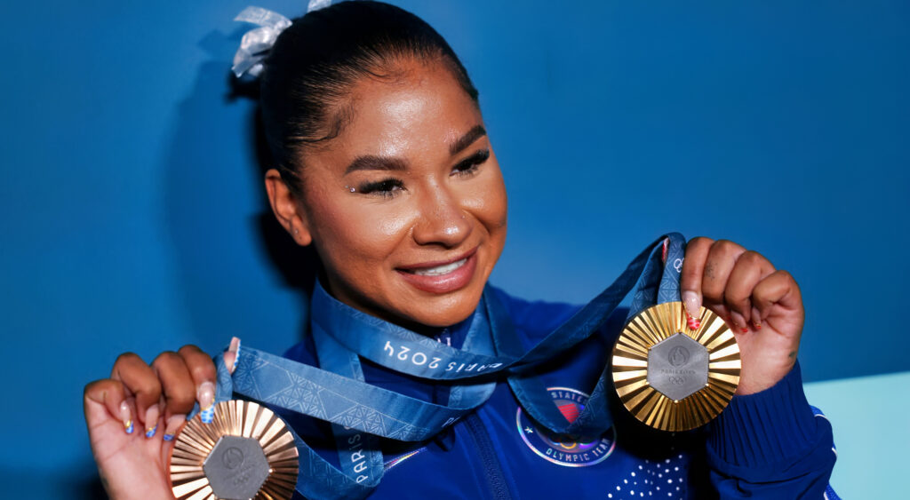 Jordan Chiles holding her medals