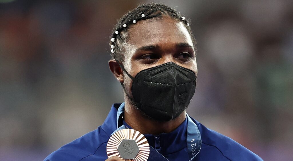 Noah Lyles holding medal