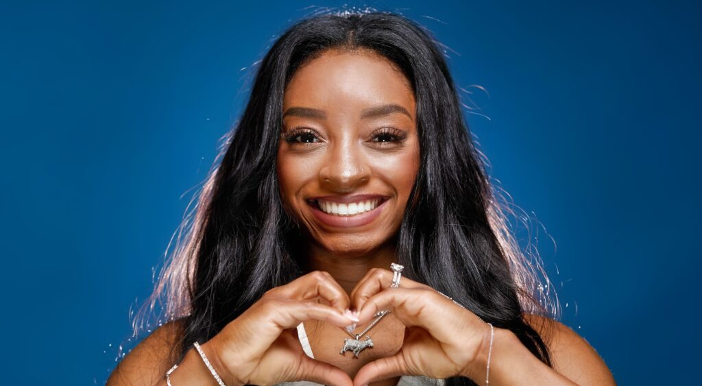 Simone Biles holding up heart sign