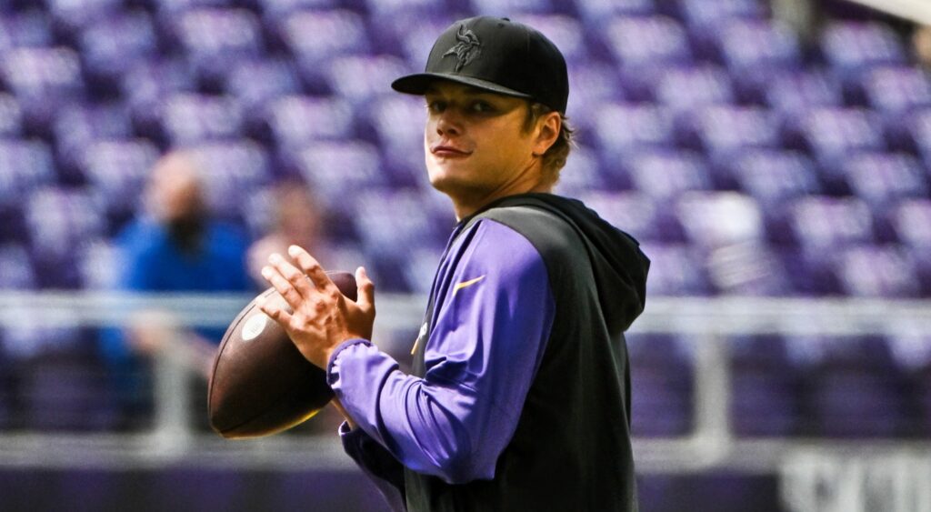 JJ McCarthy of Minnesota Vikings throwing football.