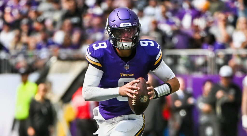 Minnesota Vikings quarterback JJ McCarthy carrying football.