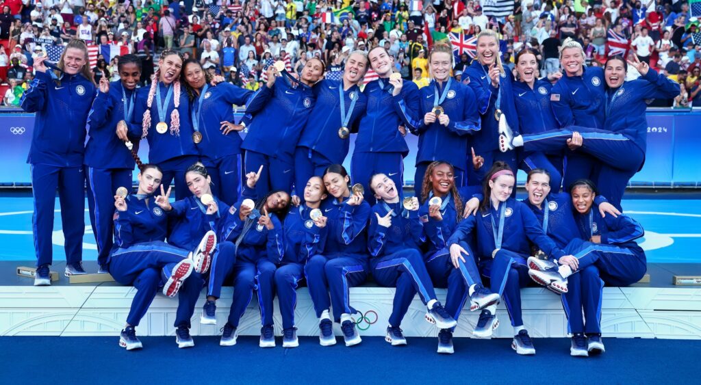 Mallory Swanson and United States women's national soccer team posing with gold medals.