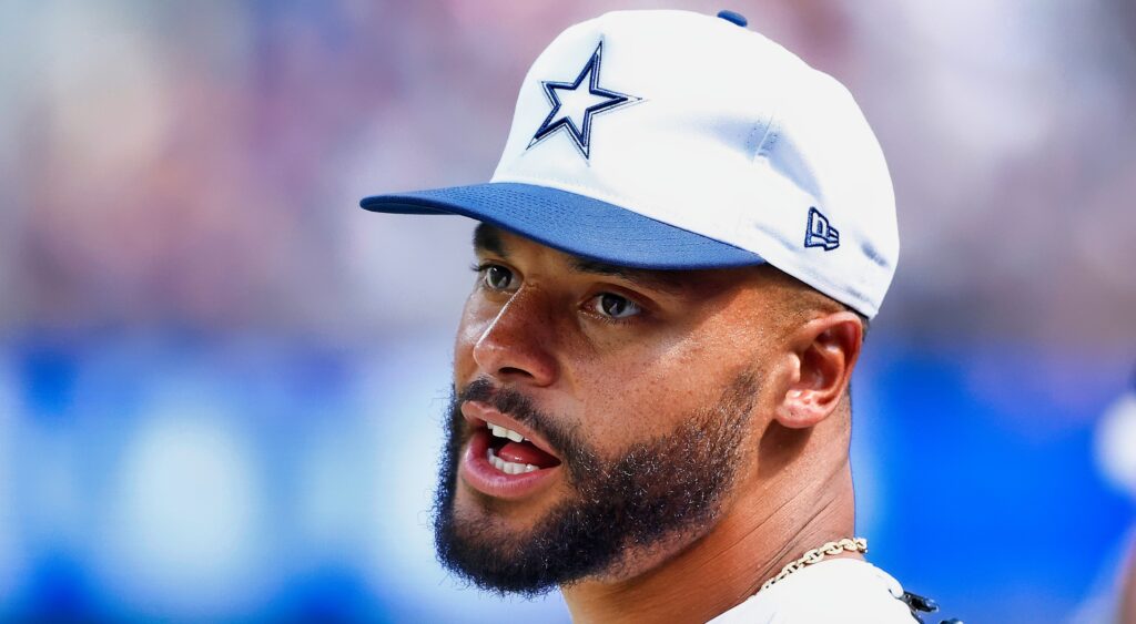 Dak Prescott talking while on the sideline.