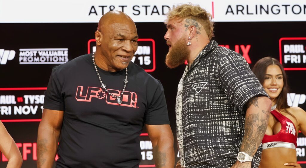 Mike Tyson and Jake Paul speaking at event.