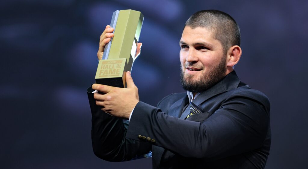 Khabib Nurmagomedov receives his jacket and trophy during the UFC Hall of Fame induction