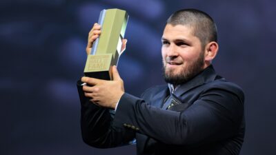 Khabib Nurmagomedov receives his jacket and trophy during the UFC Hall of Fame induction