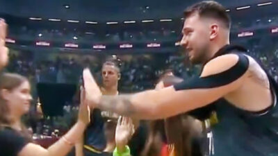 Luka Doncic high-fiving a kid