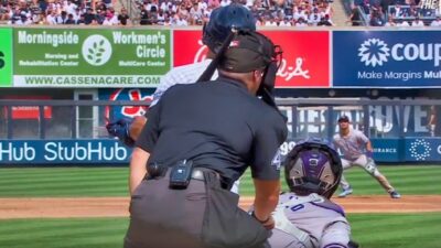 Umpire Nick Mahrley getting hit with a bat