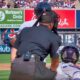 Umpire Nick Mahrley getting hit with a bat