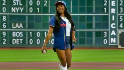 Simone Biles smiling with baseball in hand