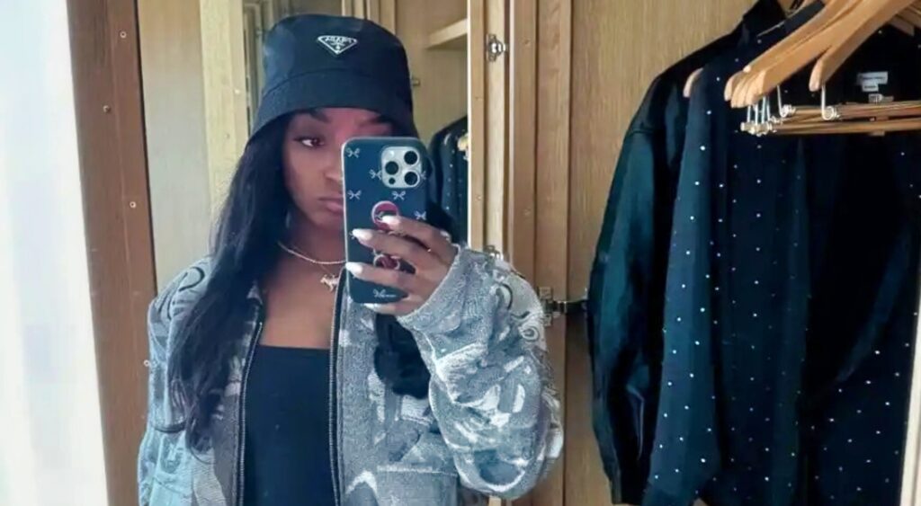 Simone Biles posing in jacket