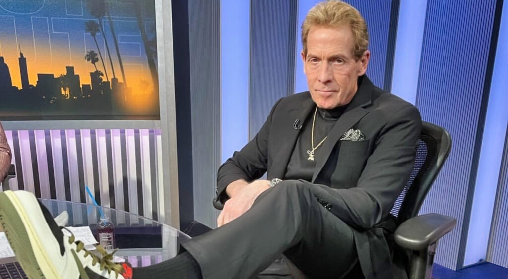 Skip Bayless with a foot on a desk