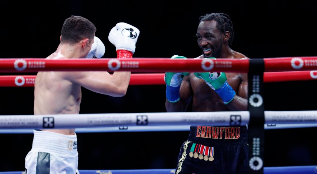  Terence Crawford smiles at Israel Madrimov during the tenth round